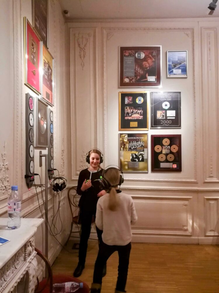 Two girls using headphones to listen to music at the Haus der Muzik in Vienna