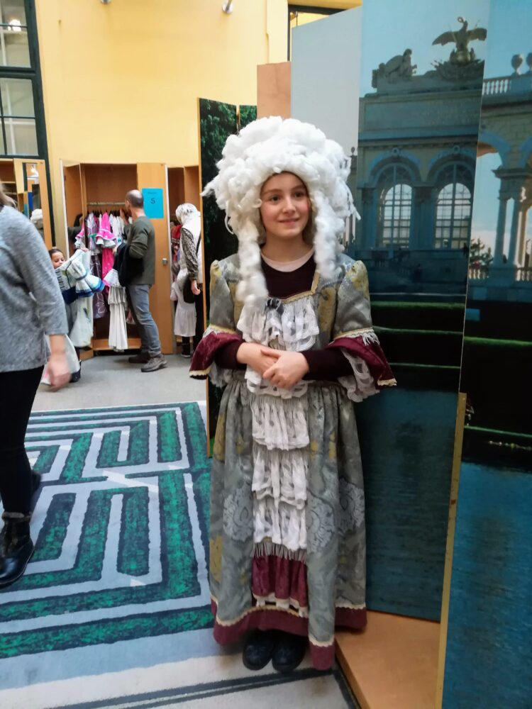 Girl wearing a 17th-century costume with wig at the Children's Museum Vienna