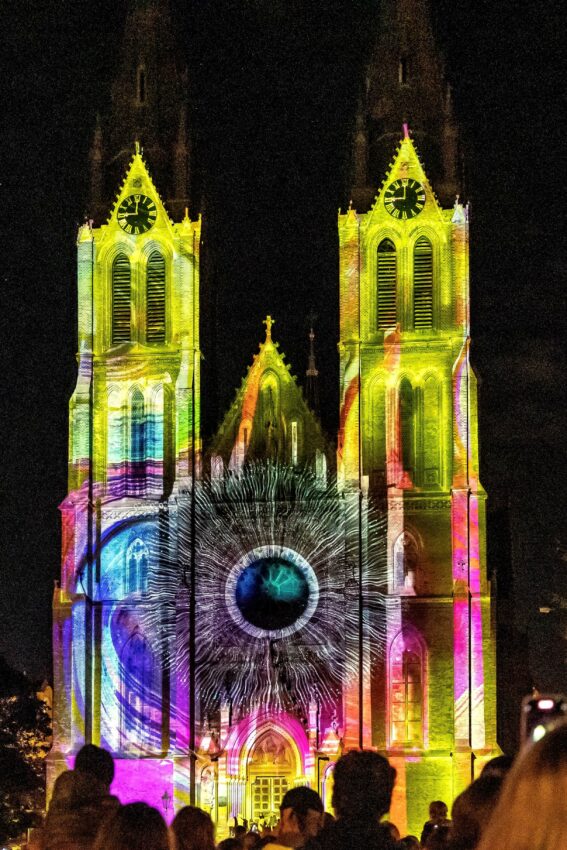 A church lit up by a colorful light installation at the Signal Festival