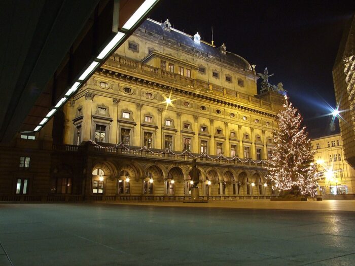 View of the National Theater in Prague, Czech Republic, with a Christmas tree in front 