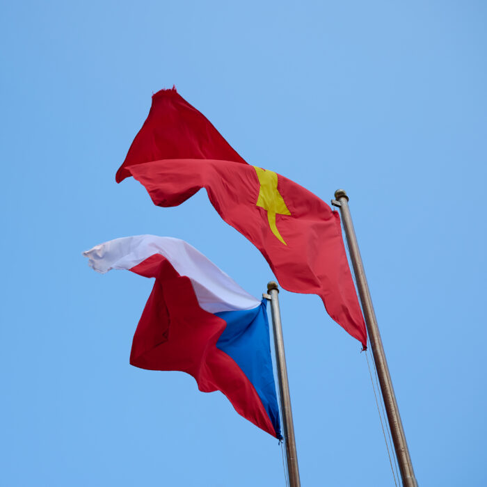 The flag of the Czech Republic and the Socialist Republic of Vietnam against the blue sky