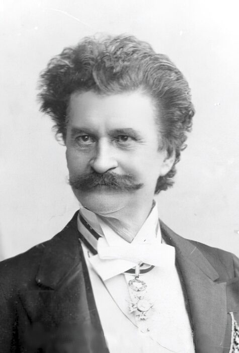 Portrait of Viennese composer Johann Strauss from 1890, a middle-aged man with dark hair and a mustache in a tuxedo