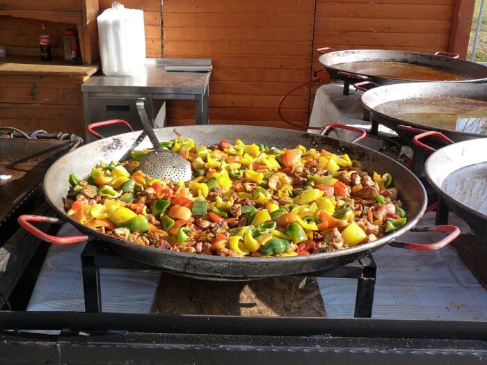 Mangalica meat cooking with bell peppers in a big pan in Budapest, Hungary