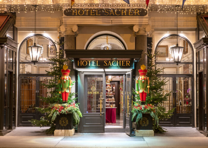 The entrance of the luxury Hotel Sacher , famous for the Sachertorte, with Nutrackers standing on each side of the doors.