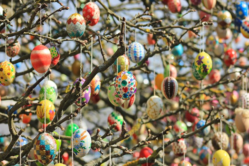 Hundreds of colorful Easter eggs hanging from a tree on a sunny day in Germany