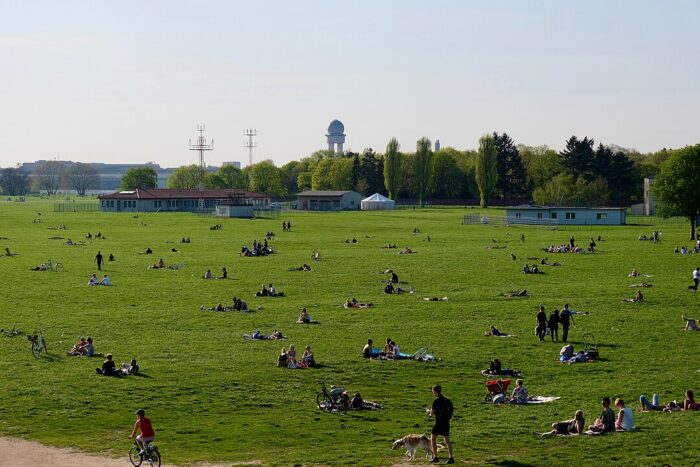 People relaxing in Tempelhof PArk in Berlin on a sunny spring day