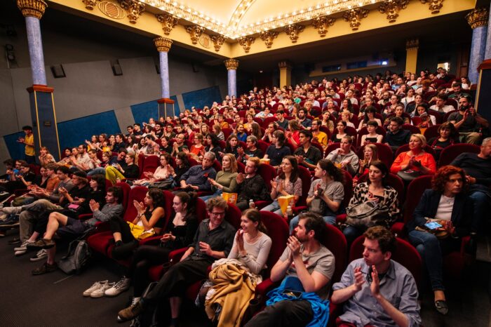 A full house in a cinema in Budapest, Hungary - inside an auditorium with people in every seat