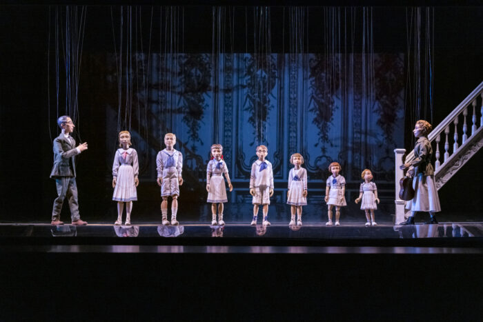 A line of marionette puppets representing the Trapp family in the Sound of Music at the Salzburg Marionette Theater