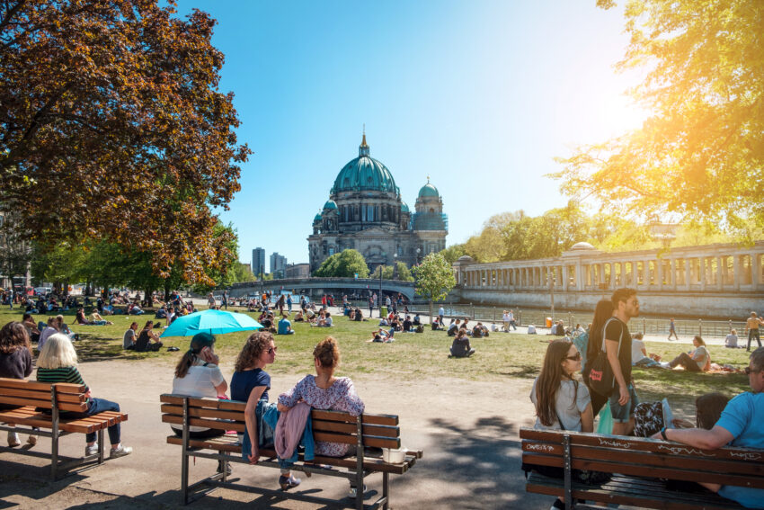 People in public park on a sunny day near Museum Island and Berlin Cathedral