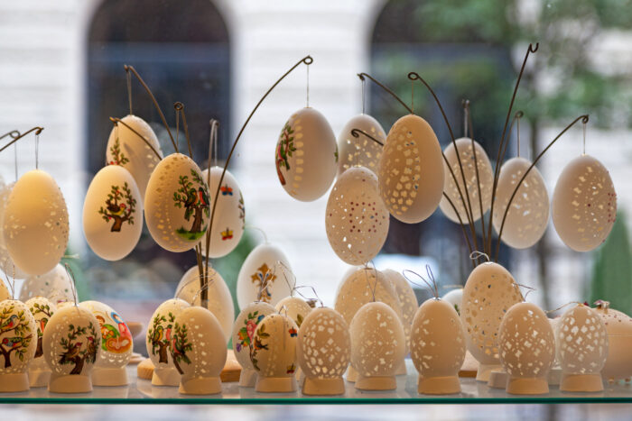 Carved goose eggs for sale in the retail display of a gift shop in Budapest.